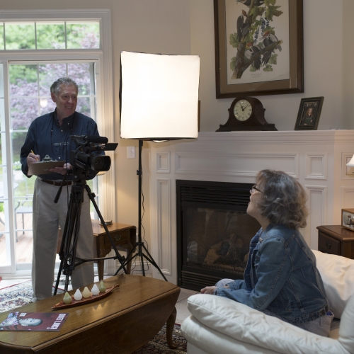 Ron Hurt ’67 and his wife Pam film a television episode in their living room.