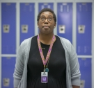 Kimberly St. Julian-Vernon in front of blue lockers