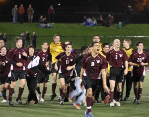 Philippe Celestin '11 leads the mens soccer team in celebration