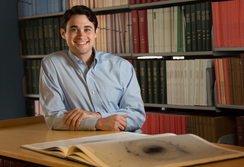 man in blue shirt in library