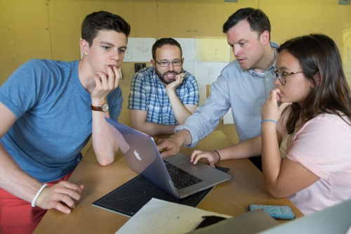 students and professors discussing their projects