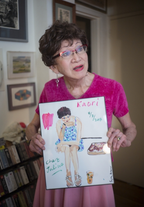 Kaori Kitao holding a painting of herself