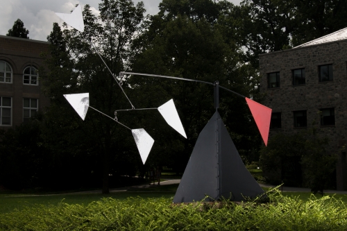 Photo of an outdoor mobile behind a building.