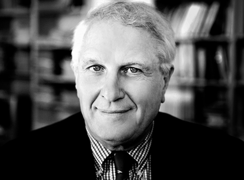 A black and white headshot of Josef Joffe ’65
