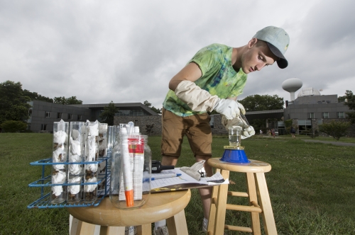 Brian Shields '18 trapping and marking bees outside Swarthmore's Science Center.