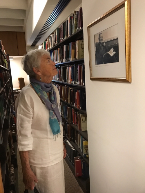 woman looking at painting in library