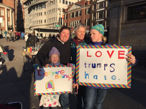 portrait of Megin ’97 and Katie Charner-Laird ’96 with their family at a peaceful protest