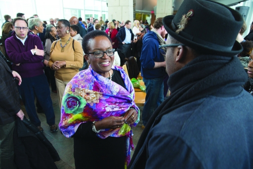 In the middle of a crowd, Valerie Smith smiles and greets people