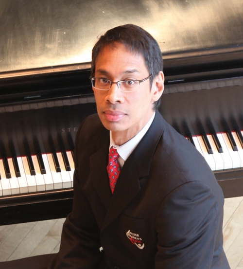 man sitting in front of a piano