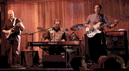 a rock band plays in a wood-paneled room