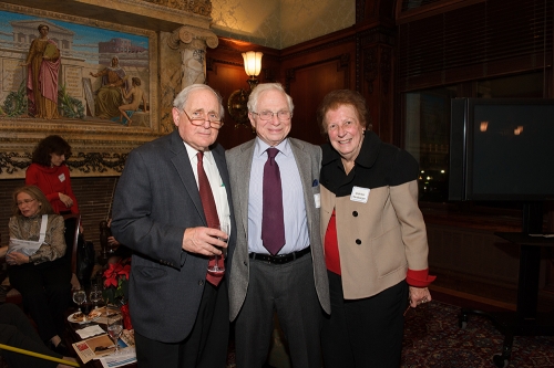 three adults smile for the camera in a beautifully painted room