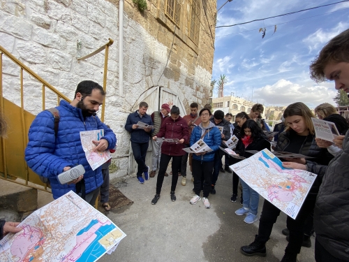 Tourists in a group looking at a map