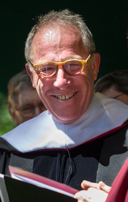 portrait of man in glasses and a graduation hood and robe