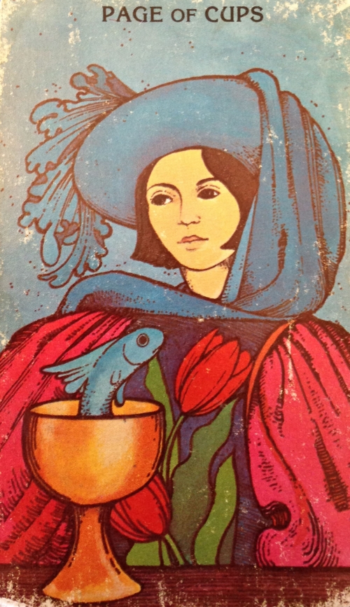 page of cups tarot card with fish