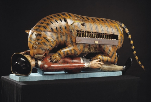 A sculpture of a tiger eating a soldier.