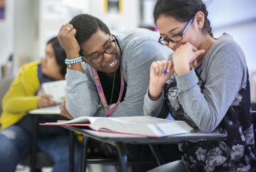 Kimberly St. Julian-Vernon helping a student, smiling