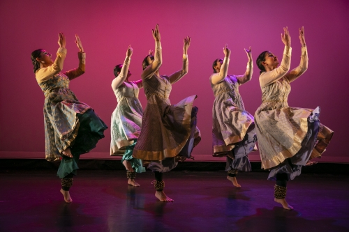 Dancers against a pink backdrop