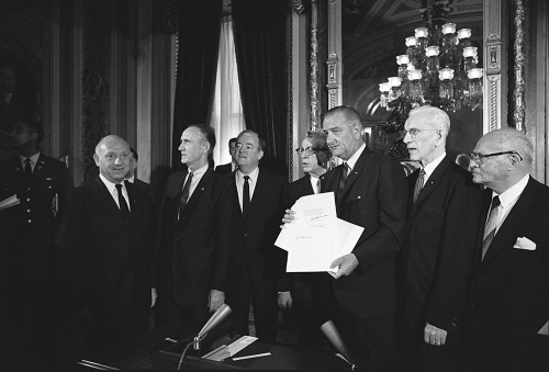 With Republican senator Everett Dirksen, who appears left of the president, Lyndon B. Johnson holds a just-signed copy of the Voting Rights Act bill at the Capitol in 1965. These politicians from opposing parties represent a model for civility today.