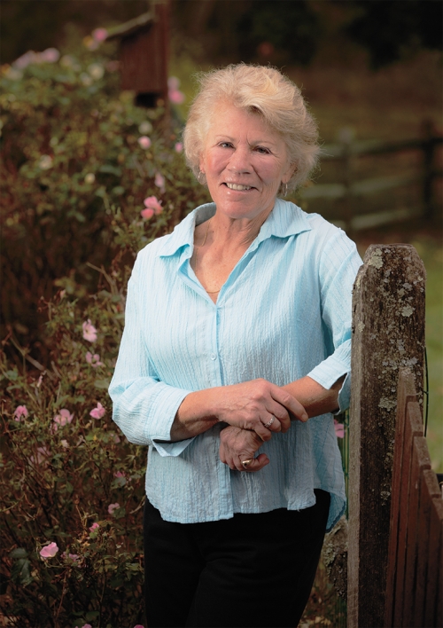 A woman with blonde hair looks at the camera. 