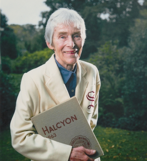 Diana Judd Stevens ’63, is an older woman with gray hair. She smiles at the camera. “The College had a couple of station wagons. I got authorized to drive one to Chestnut Hill, and the engine died on Route 320. We got it fixed and made it to the meet on time.” 