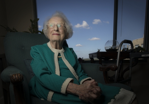 Nancy Grace Roman in a green suit, seated and looking slightly upward