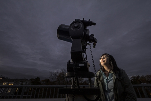 Linda Vu looks through telescope 