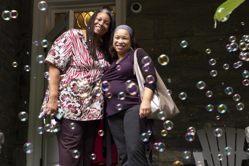 Karen Henry and Sha Duncan Smith hugging with bubbles surrounding them