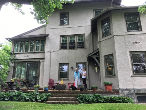 two women in front of a house