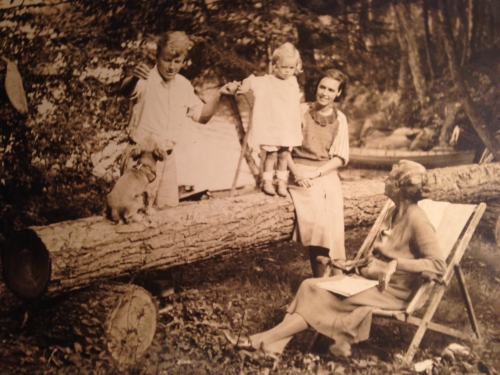 family sitting on a log 