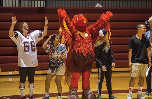 The phoenix mascot cheers on the crowd