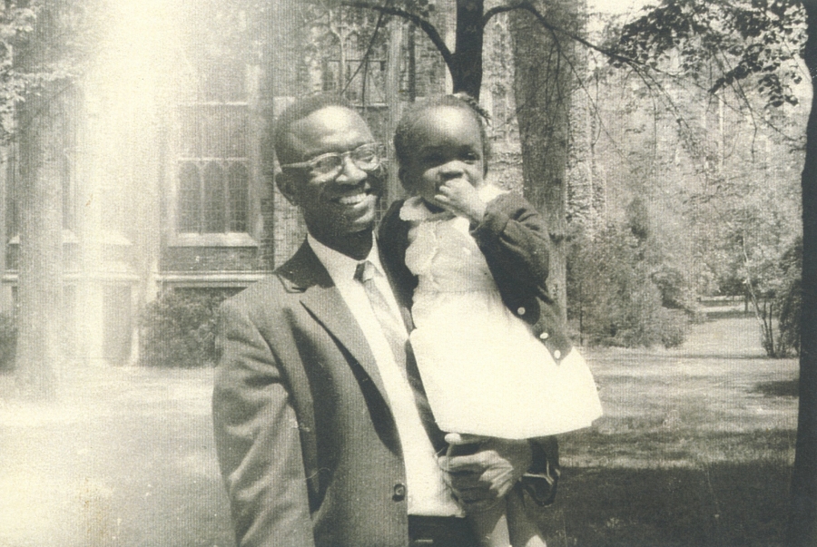 A black and white photo of President Val Smith as an toddler with her father.