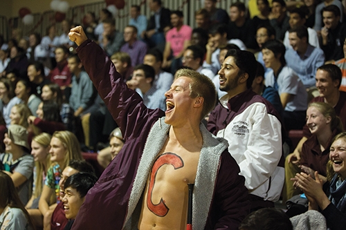A student cheers from the sidelines