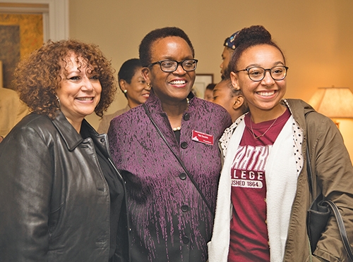 Three women smile for the camera