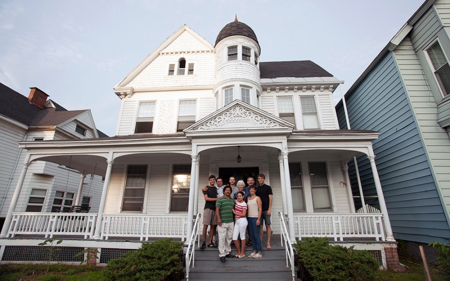 A large white house with people on the steps