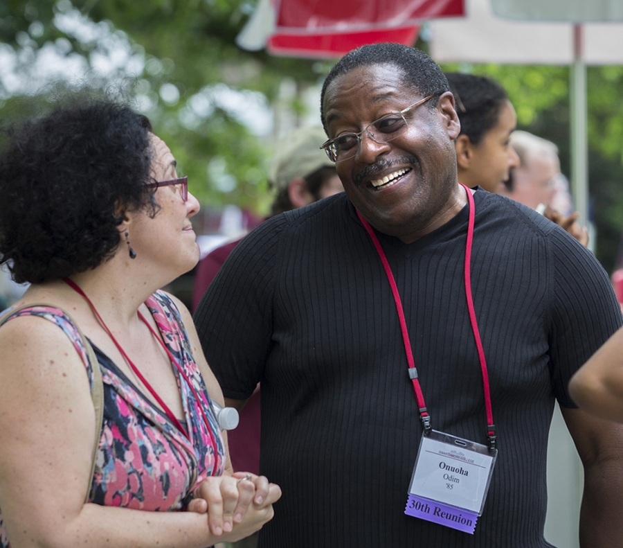 a woman and man laugh and talk at reunion