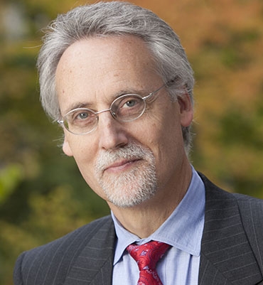 man wearing glasses and a suit and tie