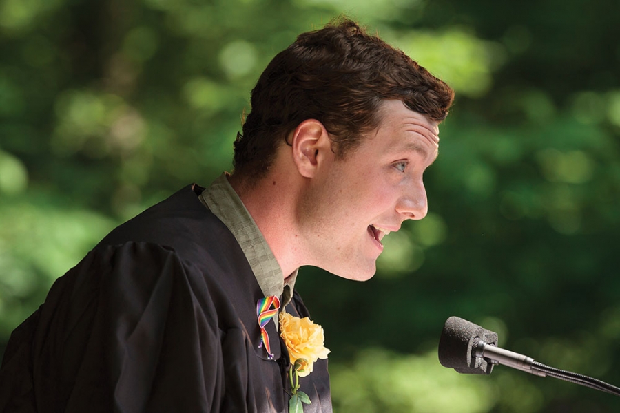 Patrick Ross leans into the mic while giving his speech.