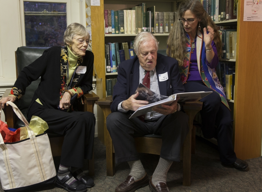 A man and a woman look at a book.  Photo by Laurence Kesterson.