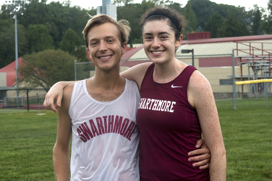 Male champion, Jacob Phillips '13, and female champion, Katie Jo Mcmenamin '16, stand smiling after the Swarthmore College Alumni Run. 