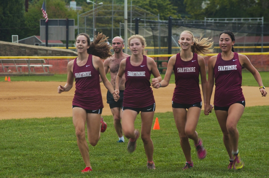Cross country teammates finish hand in hand at the Swarthmore College Alumni Run.