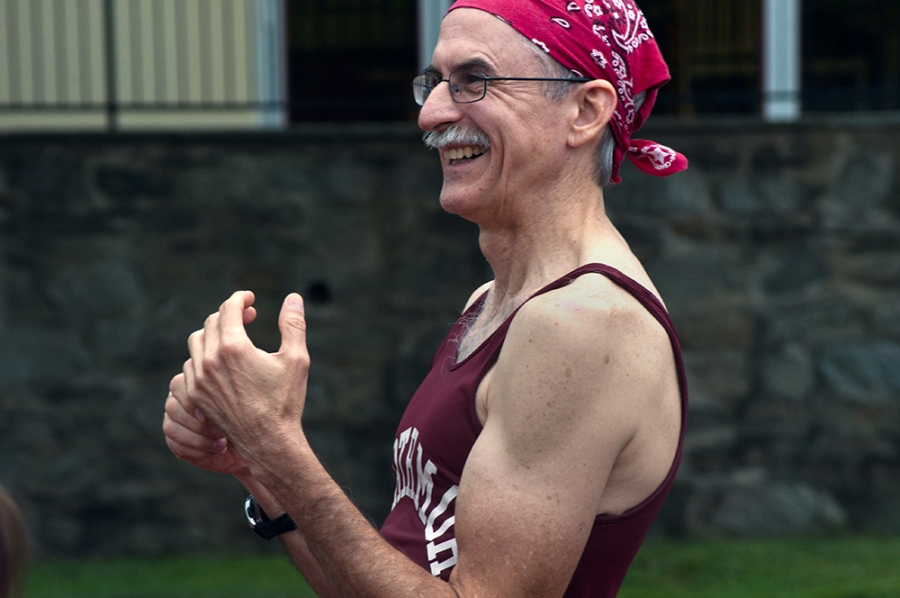 A man smiles while running. 