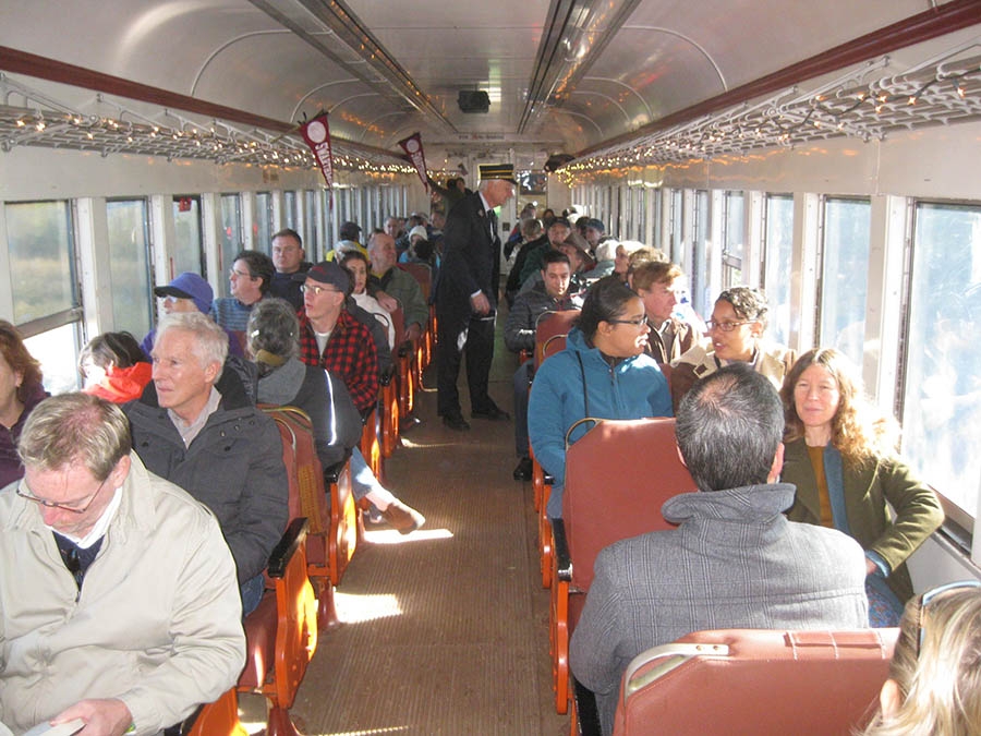 People are sitting on a train. 