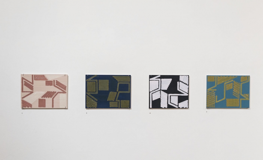 A collection of four geometric paintings.