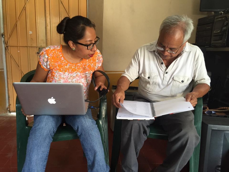 woman and a man look at a computer 