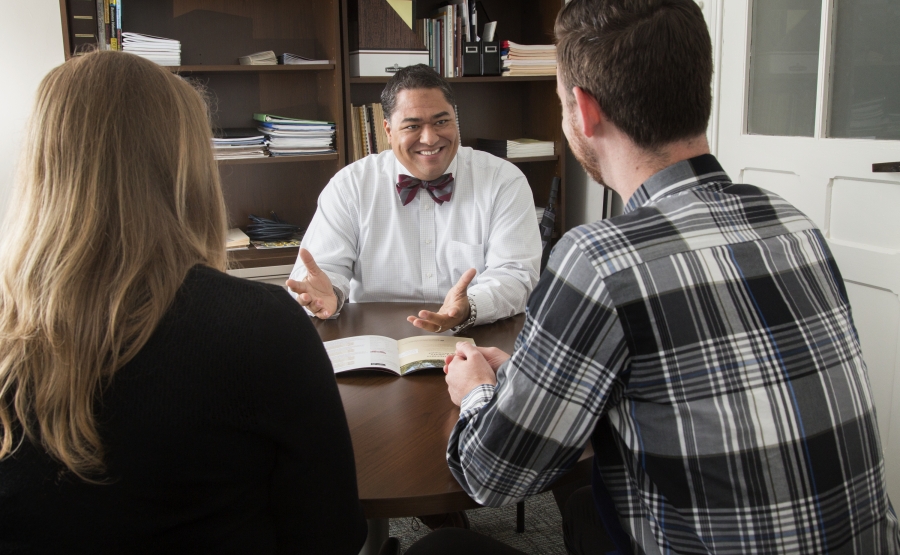 Varo Duffins counsels two people in his office