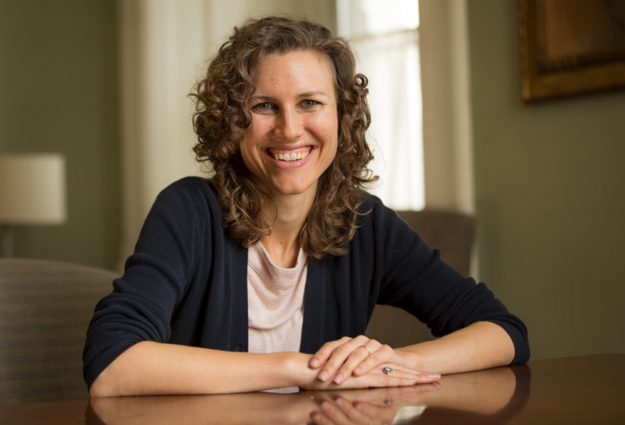 woman sitting at table looking at camera