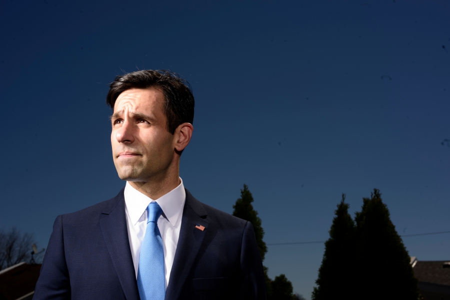 Joe Khan in a suit against a blue sky