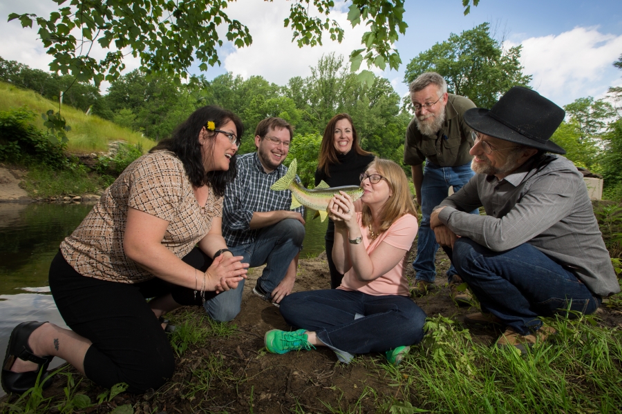 The Bulletin staff on the banks of the Crum Creek, looking at class notes editor Elizabeth Slocum kissing a fish