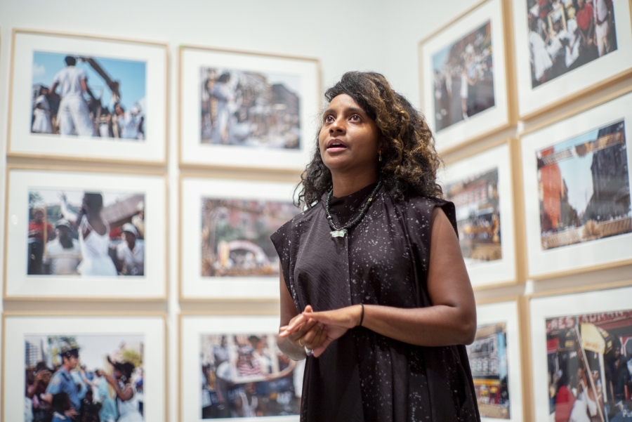 Zoe Whitley in front of photographs from her exhibition.