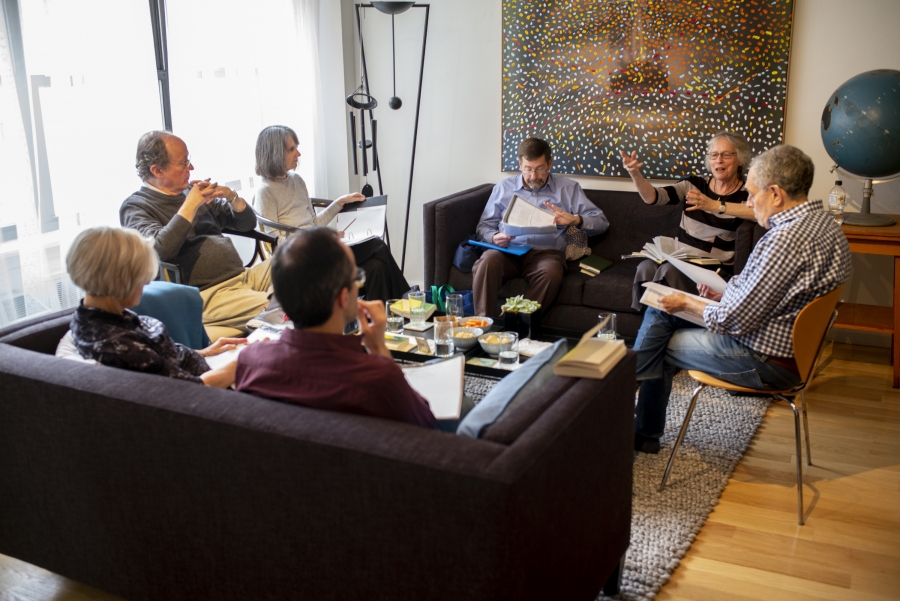 Group of people sit and read 